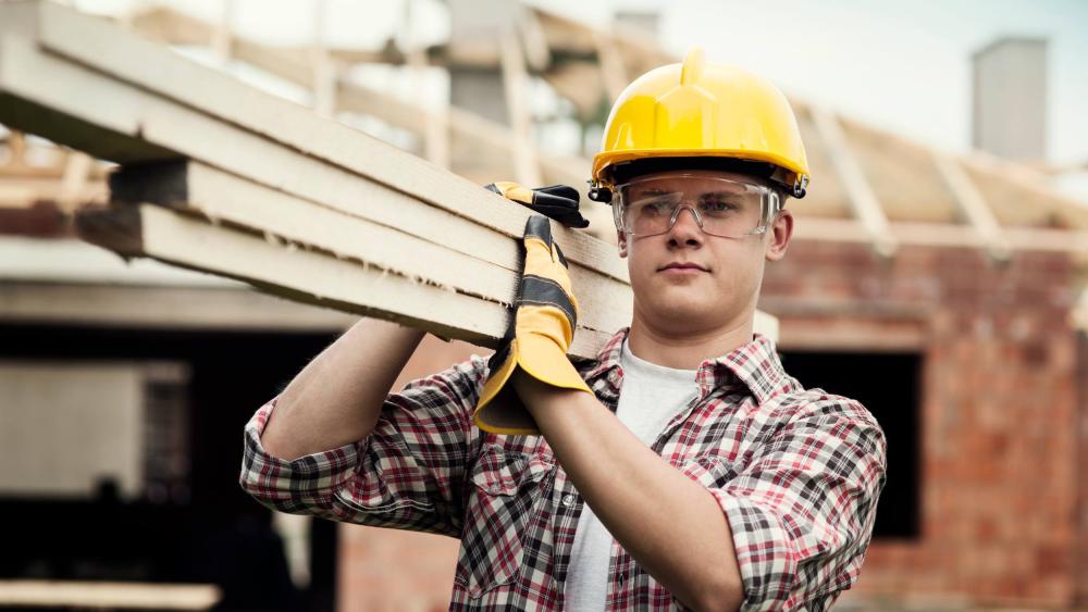 man carrying wood
