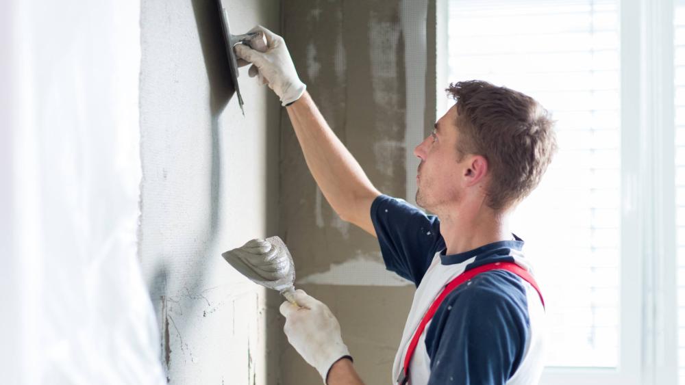 Man plastering the wall