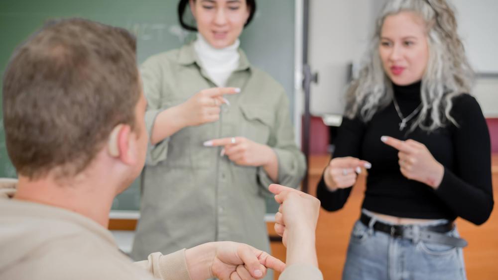 two people using sign language to communicate