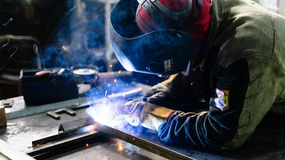 person wearing protective gear and welding