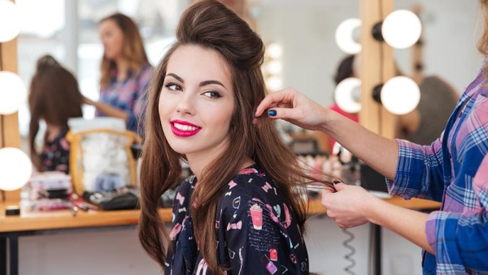 Woman sat in hair and make up / menyw mewn gwallt a cholur