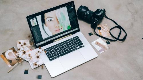 Computer with editing software next to a camera