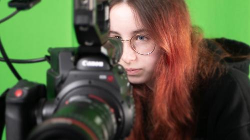Person looking through a video camera